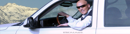 Smiling man with glasses in Escalade